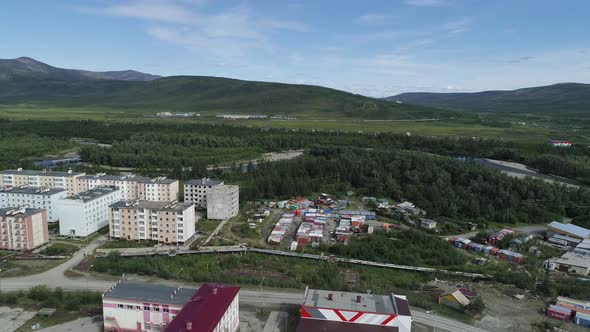 Aerial view of a small town among forests and hills. 09
