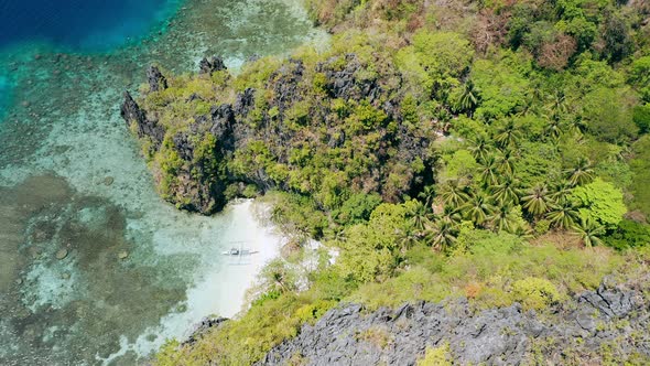 Aerial Footage of Small Beach Near Big Lagoon with Lonely Banca Local Boat on Paradise Sandy Beach