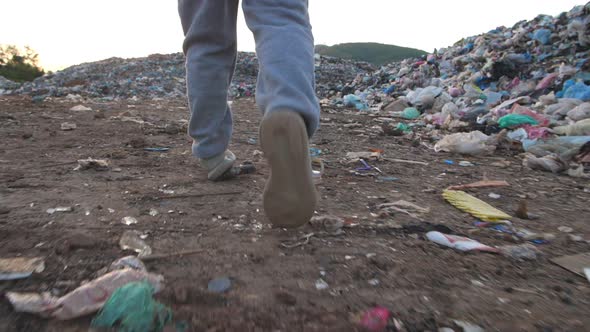 Legs Boy Walking, Garbage At Background alt