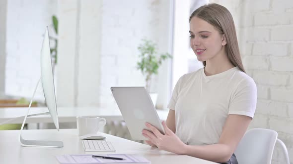 Beautiful Young Woman Using Tablet in Modern Office 