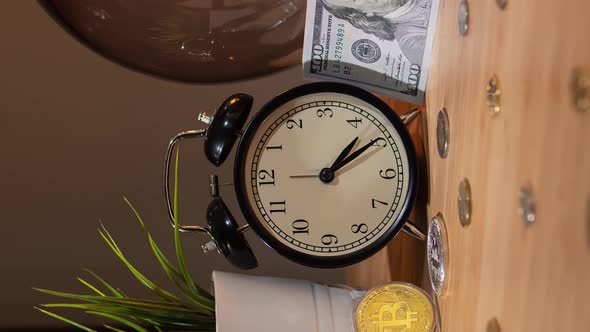 Bitcoin Fast Rising Price. Time Lapse. Close-up View of Bitcoins, Alarm Clock and Small Bundle of