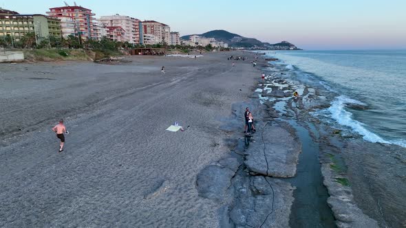 A man runs on the beach aerial view 4 K Turkey Alanya