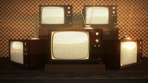 An exhibition of old-fashioned retro color tv sets with tuner antennas.