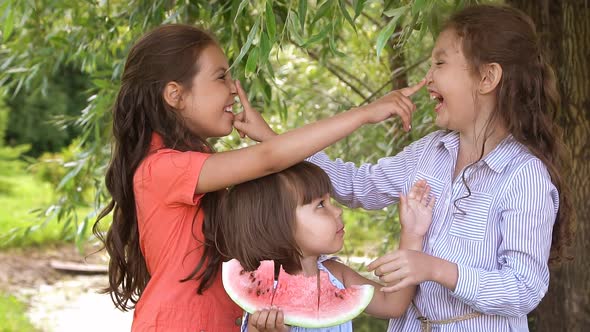 Group of Children Eating Watermelon Outdoors