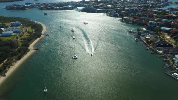 Sovereign Island and Paradise Point, sun glistening off canal, luxury homes and boats. Australia