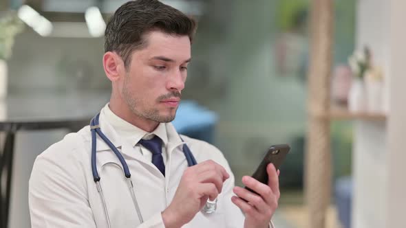 Focused Young Male Doctor Using Smartphone