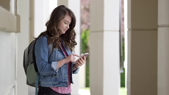 Young woman typing on smartphone using app