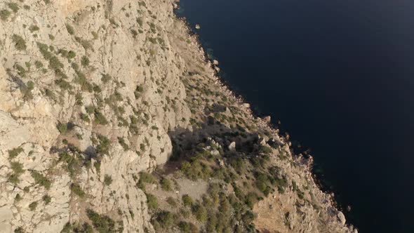 Rocky Cliffs of Brown Colour with Bushes Under Sunlight