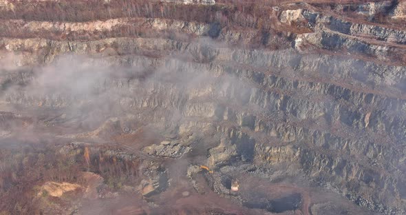 Aerial Top View of Landscape Morning Fog on Mountain with Quarry Extracting Mine Industry