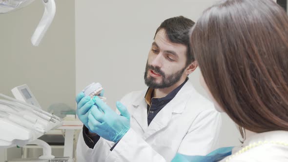 Professional Dentist Educating His Female Patient During Medical Appointment