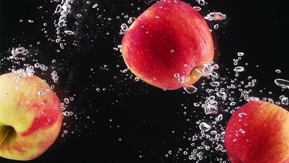 Ripe Apples Falling Through Water