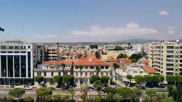 Aerial of Limassol, Camera Rises Up Above Embankment Overlooking Buildings of City