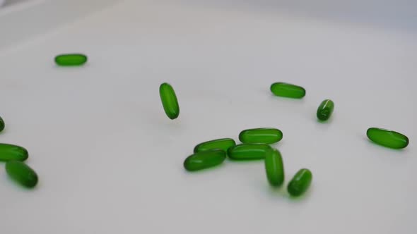 stock footage of green tablets being dropped on a table