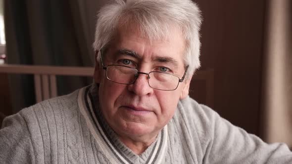 Closeup Portrait of Happy Senior Man Looking at Camera