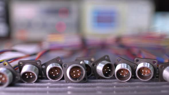 Slider Shot Video of Blurry Metal Sockets for Plugs