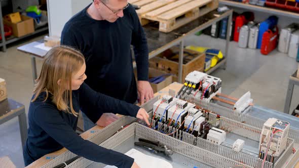 Woman discussing circuit plan with electrician