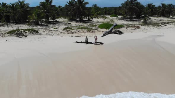 Young and Happy Couple Kissing on a Beach Tropical Vacation Aerial Shot