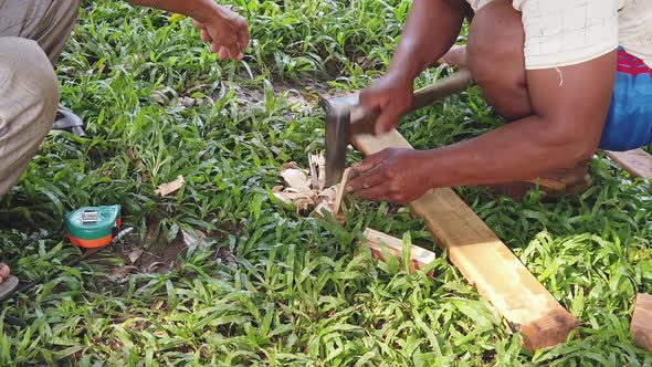 Slow Motion Shot of a Men Shaving a small piece of wood With Axe