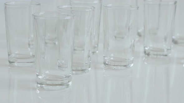 Many transparent  spirits or liquor drink glasses 4K 2160p 30fps UltraHD footage - Close-up of shot 