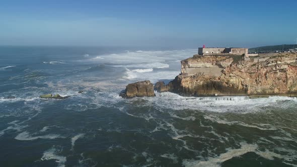 Lighthouse on Cliff on Atlantic Ocean in Nazare