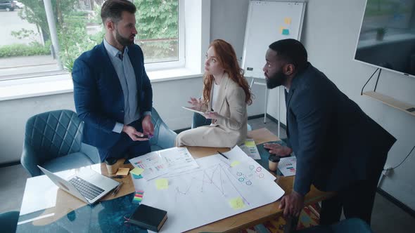 Multiracial Group of Young Creative People in Formal Wear Discussing Business Brainstorming Meeting