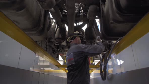 Auto Mechanic Repairs Truck Suspension