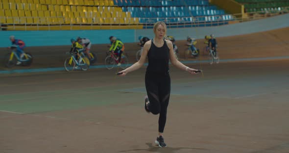 Women in Sportswear Exercising with Skipping Rope