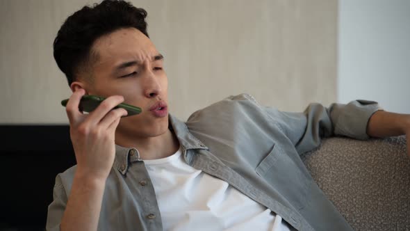 Asian Man Calls to Friend Talking About Passing Exam