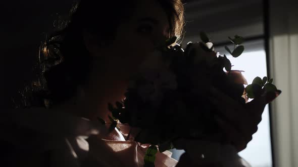 The Girl Leans the Bouquet Against Her Nose