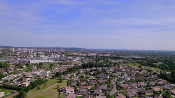 Outskirts of Montauban Southern France with residential and industrial areas, Aerial pan right shot