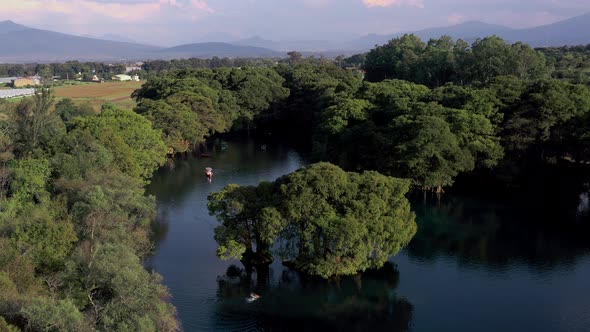 AERIAL: Lago De Camecuaro, Boat, Swimmer, Tangancicuaro, Mexico (Descending)