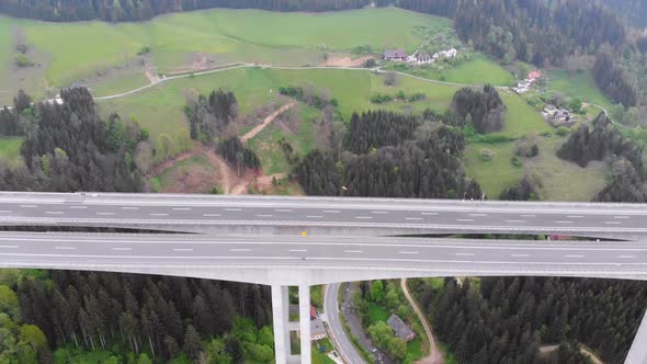 Aerial View of the Highway Viaduct on Concrete Pillars with Traffic in Mountains