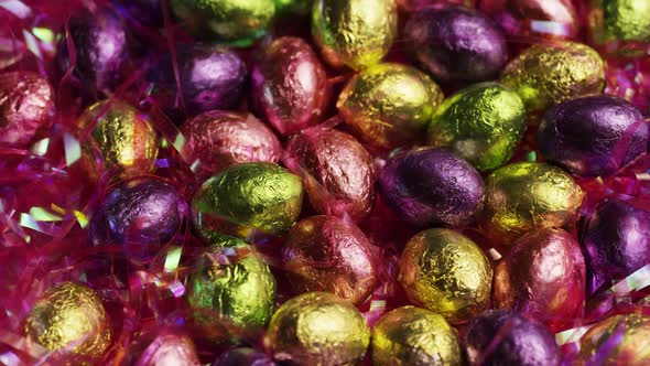 Rotating shot of colorful Easter candies on a bed of easter grass 