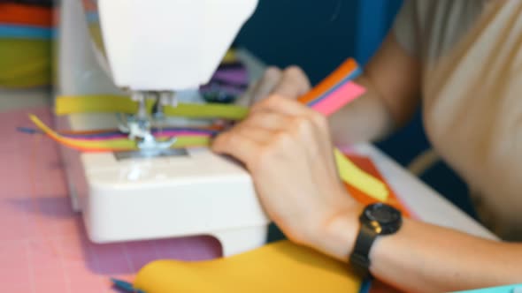 Seamstress Sews Ribbons on Professional Sewing Machine