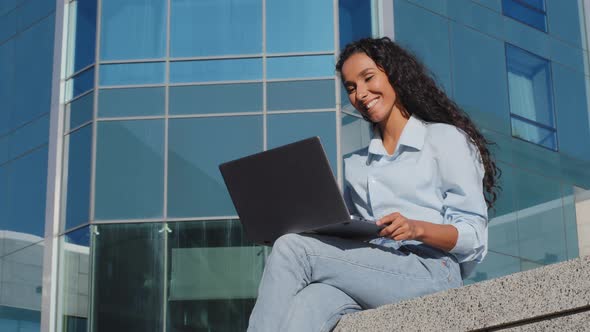Young Student Girl Using Laptop Sitting Outside in City