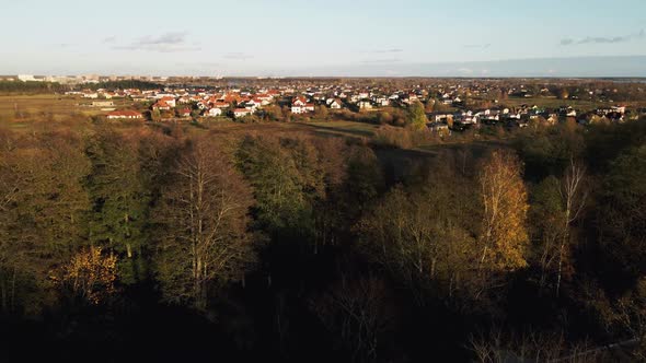 Aerial Reveal Shot of Many Small Modern Houses Near River