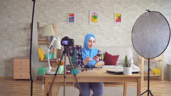 Muslim Woman in a Headscarf and Writes at the Camera Beauty Blog
