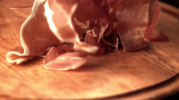 Super Slow Motion on the Cutting Board Falls Pieces of Spanish Ham