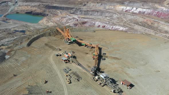 Aerial View, Lignite Coal Open Pit Mine and Heavy Machinery on Sunny Day, Orbit Drone Shot 50fps