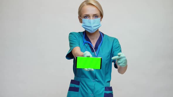 Medical Doctor Nurse Woman Wearing Protective Mask and Gloves - Showing Presenting Mobile Phone
