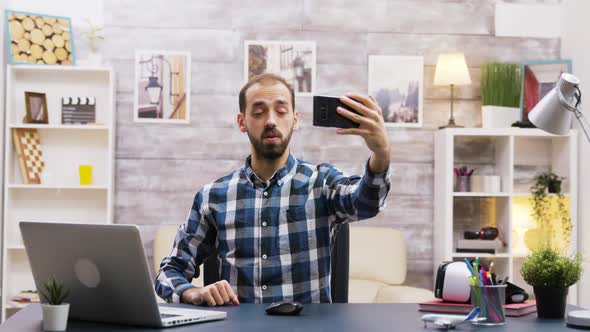 Creative Young Man Using His Phone To Record a New Episode