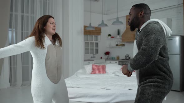 Joyful Multiethnic Couple High Five During Dance