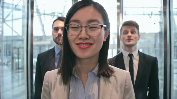 Businessmen and businesswoman in elevator