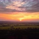 Aerial drone hyper lapse, Colorful sunset on the top of the rural village on a green field. - VideoHive Item for Sale