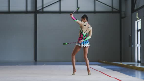 Female gymnast performing at sports hall