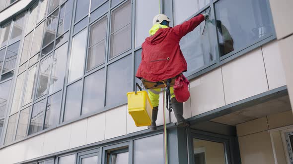 Industrial Climber Washes Windows of Office Skyscraper