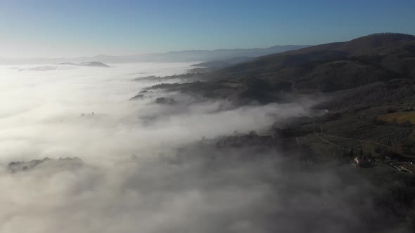 Aerial shot of fog over forest in Umbria, Italy