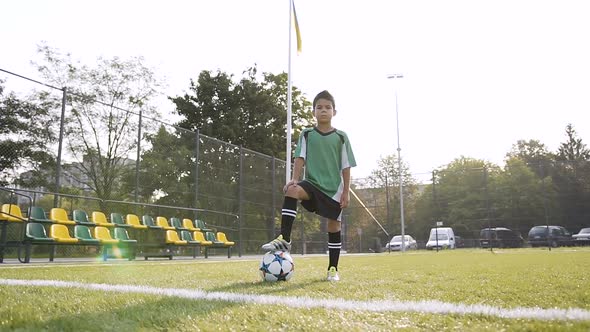 Sport Boy Looking to the Camera and Possing with Soccer Ball