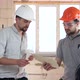An engineer and a builder are discussing a construction plan. - VideoHive Item for Sale