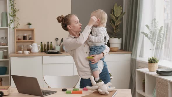 Woman Having Business Call and Babysitting